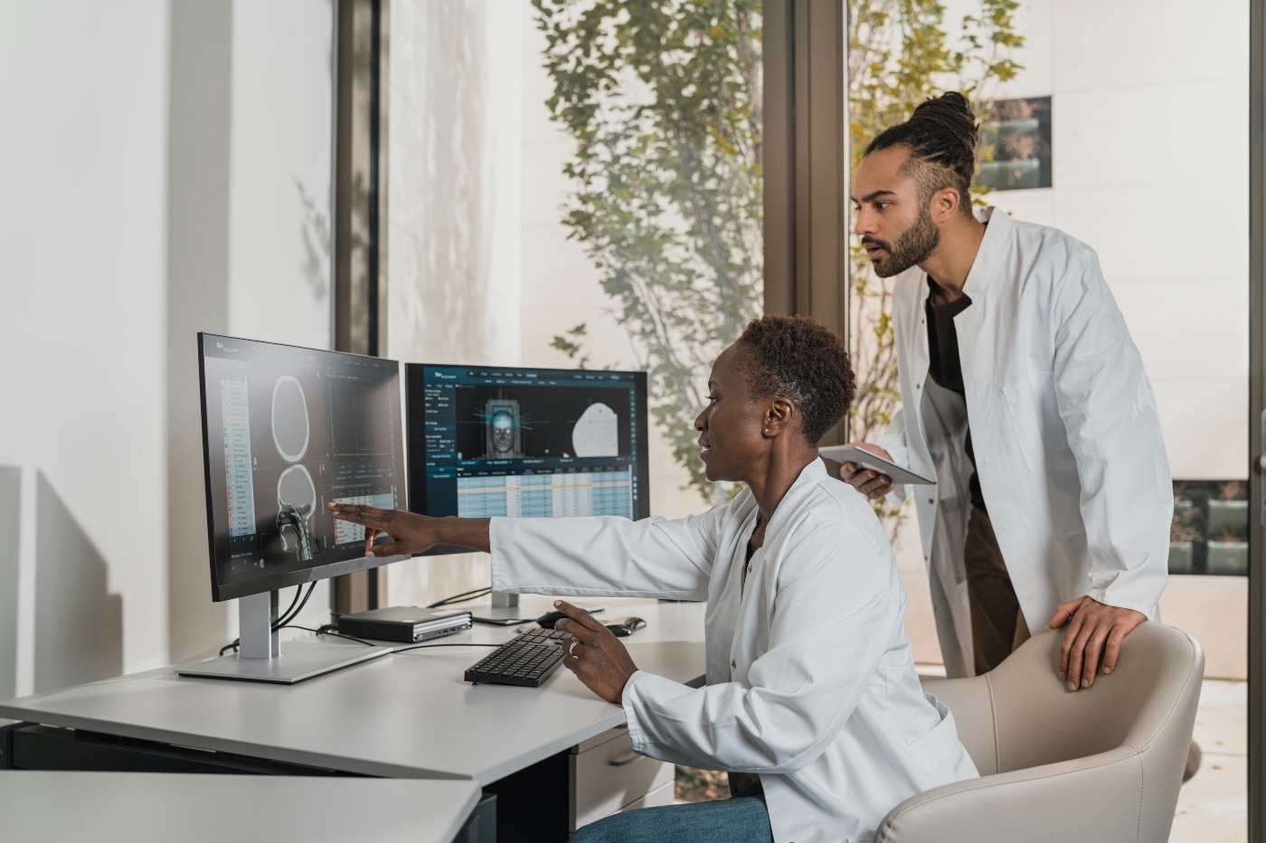 Two specialists reviewing medical scans